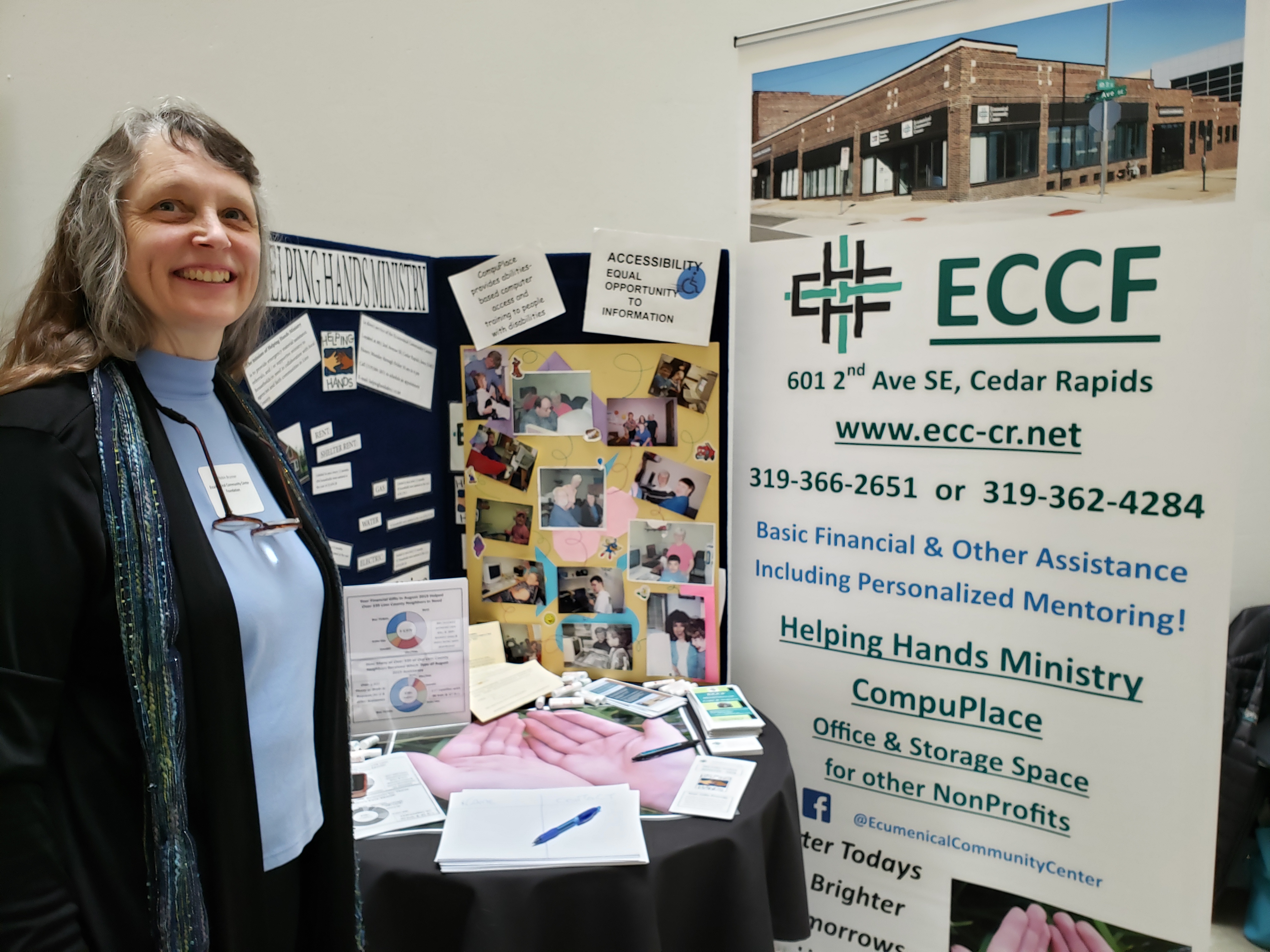 [Photo:  ECCF COO Robin Brunner by a Presentation Board at an Event]